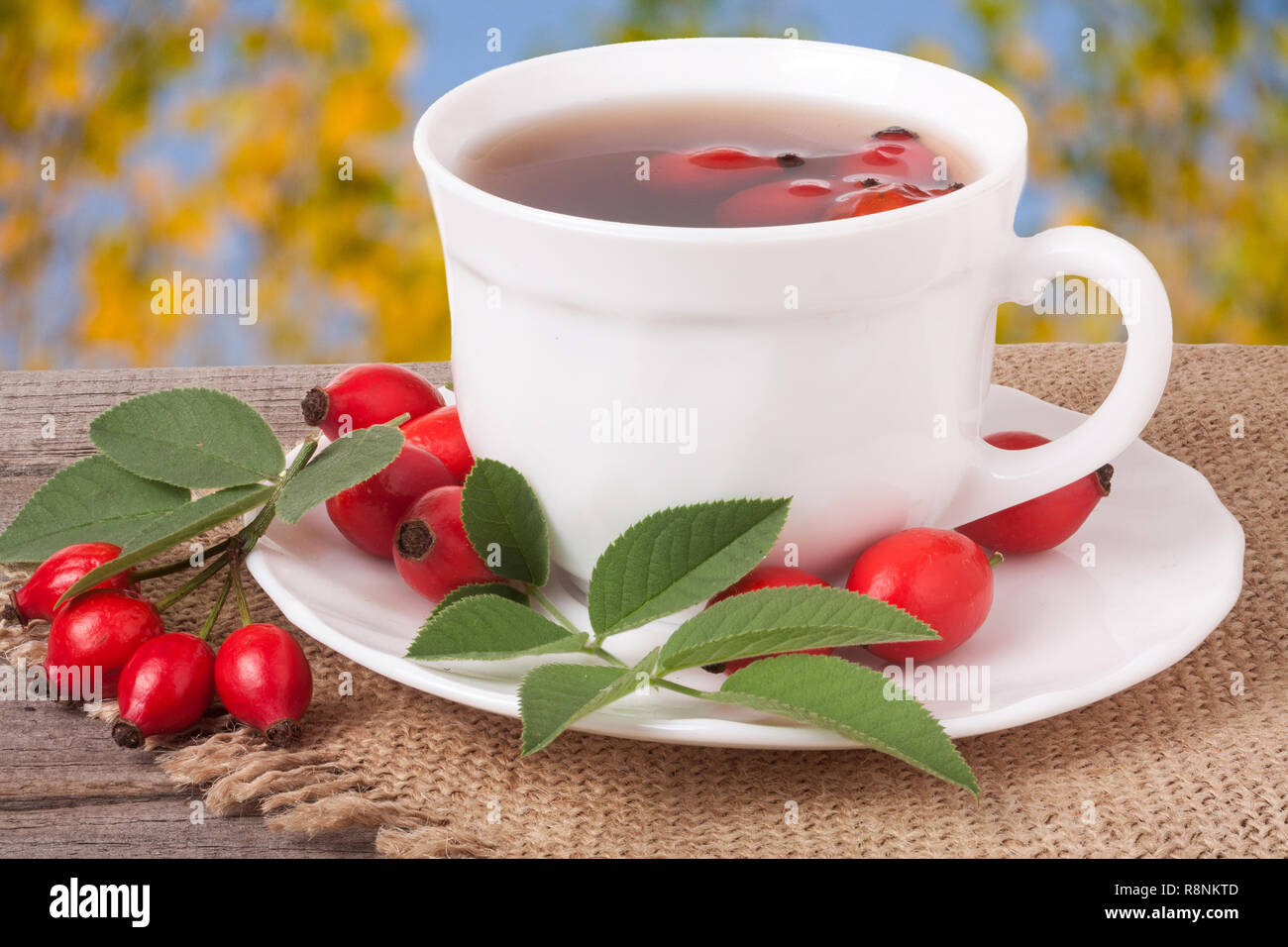 Tea from the hips on the wooden table with a blurred background Stock Photo