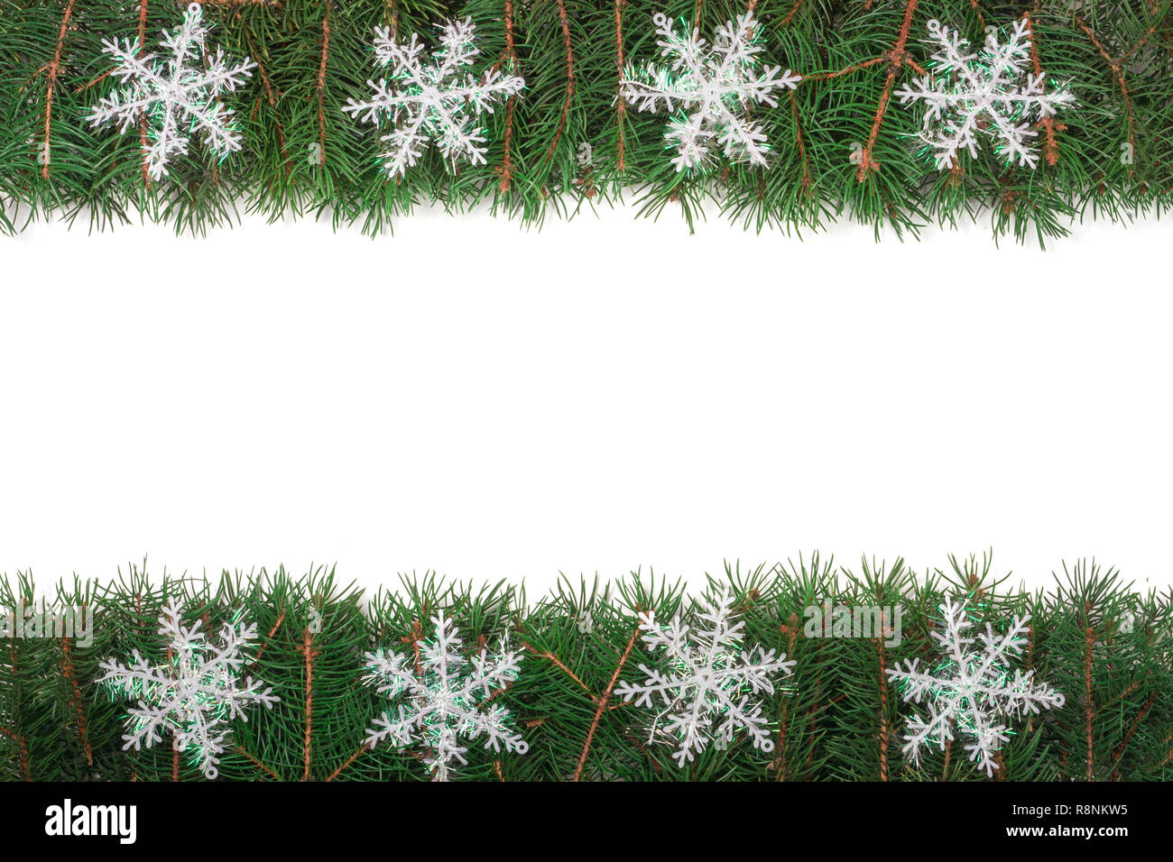 Christmas frame made of fir branches decorated with snowflakes isolated ...