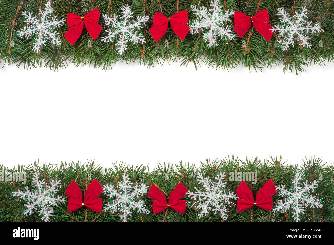 Christmas frame made of fir branches decorated with bows and snowflakes ...