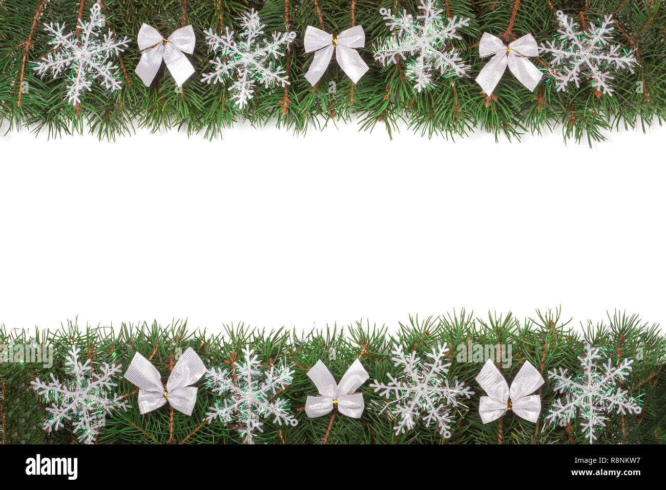 Christmas frame made of fir branches decorated with bows and snowflakes ...