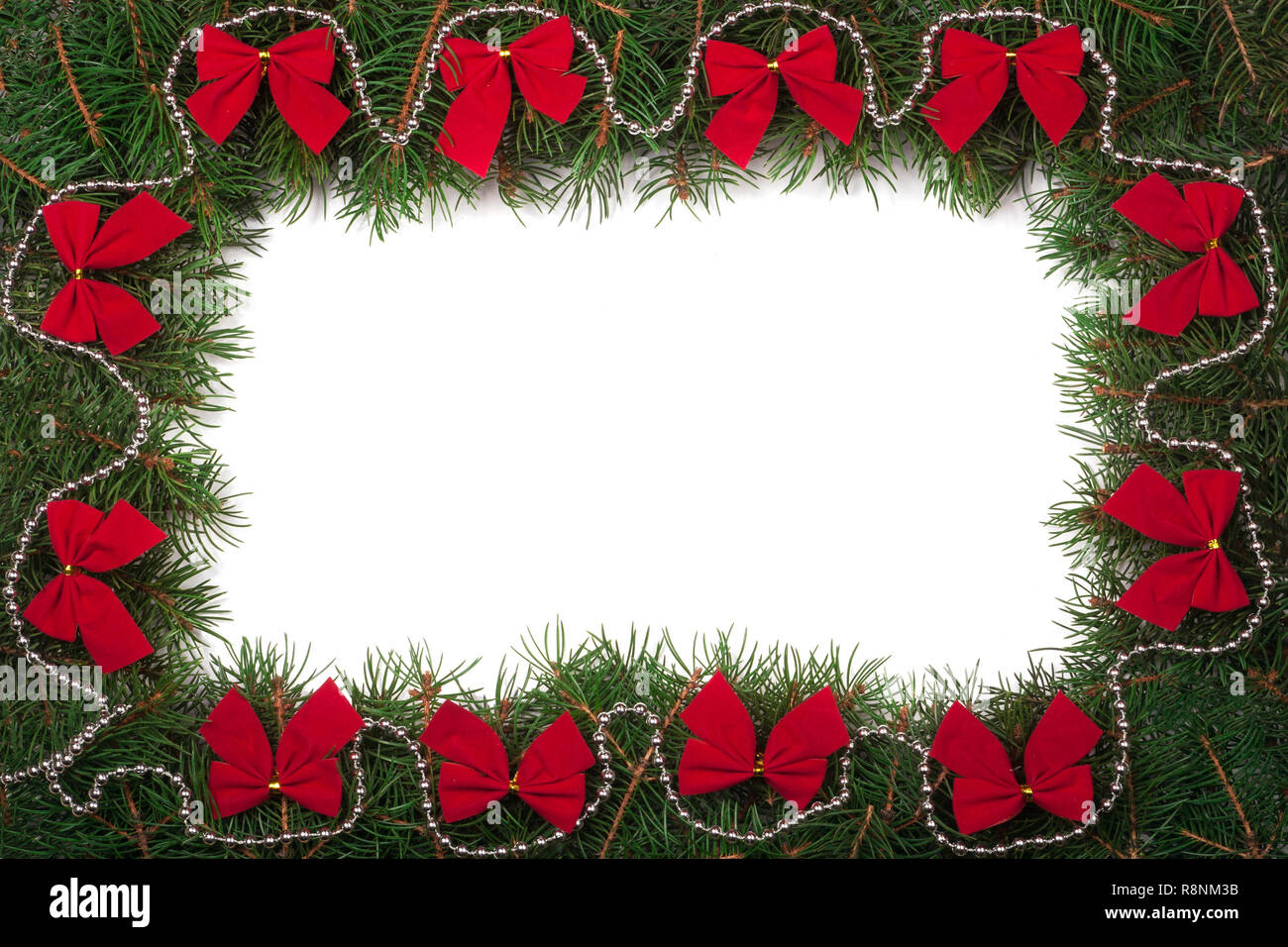 Christmas frame made of fir branches decorated with bows isolated on ...