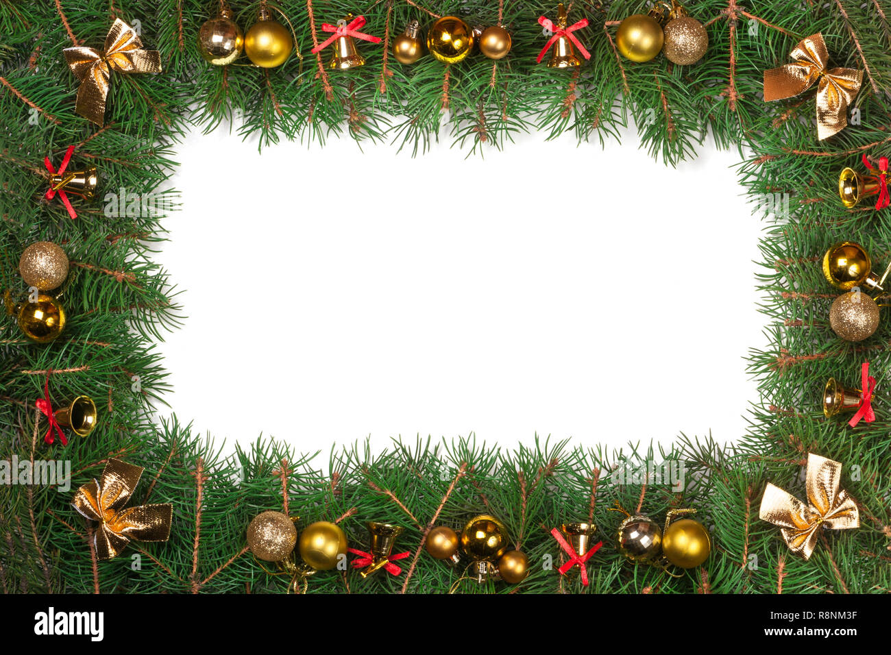 Christmas frame made of fir branches decorated with balls bells and ...