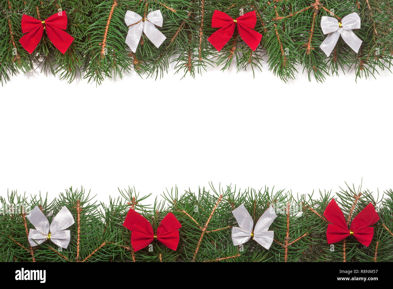 Christmas frame made of fir branches decorated with bows isolated on ...