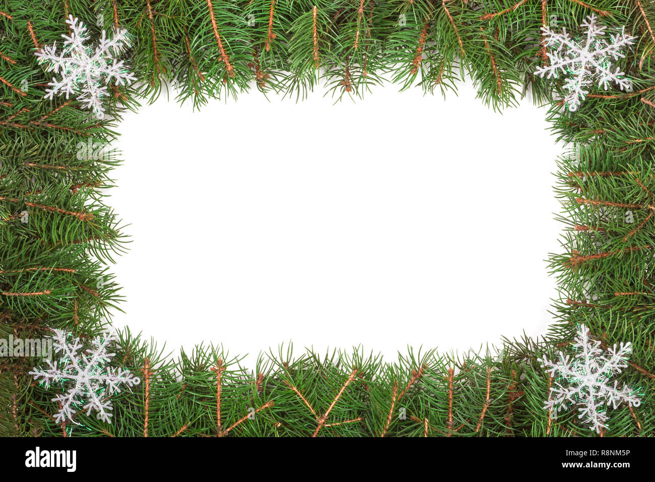 Christmas frame made of fir branches decorated with snowflakes isolated ...