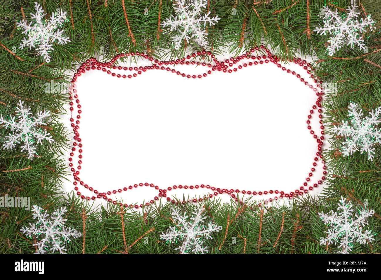 Christmas frame made of fir branches decorated with beads and ...