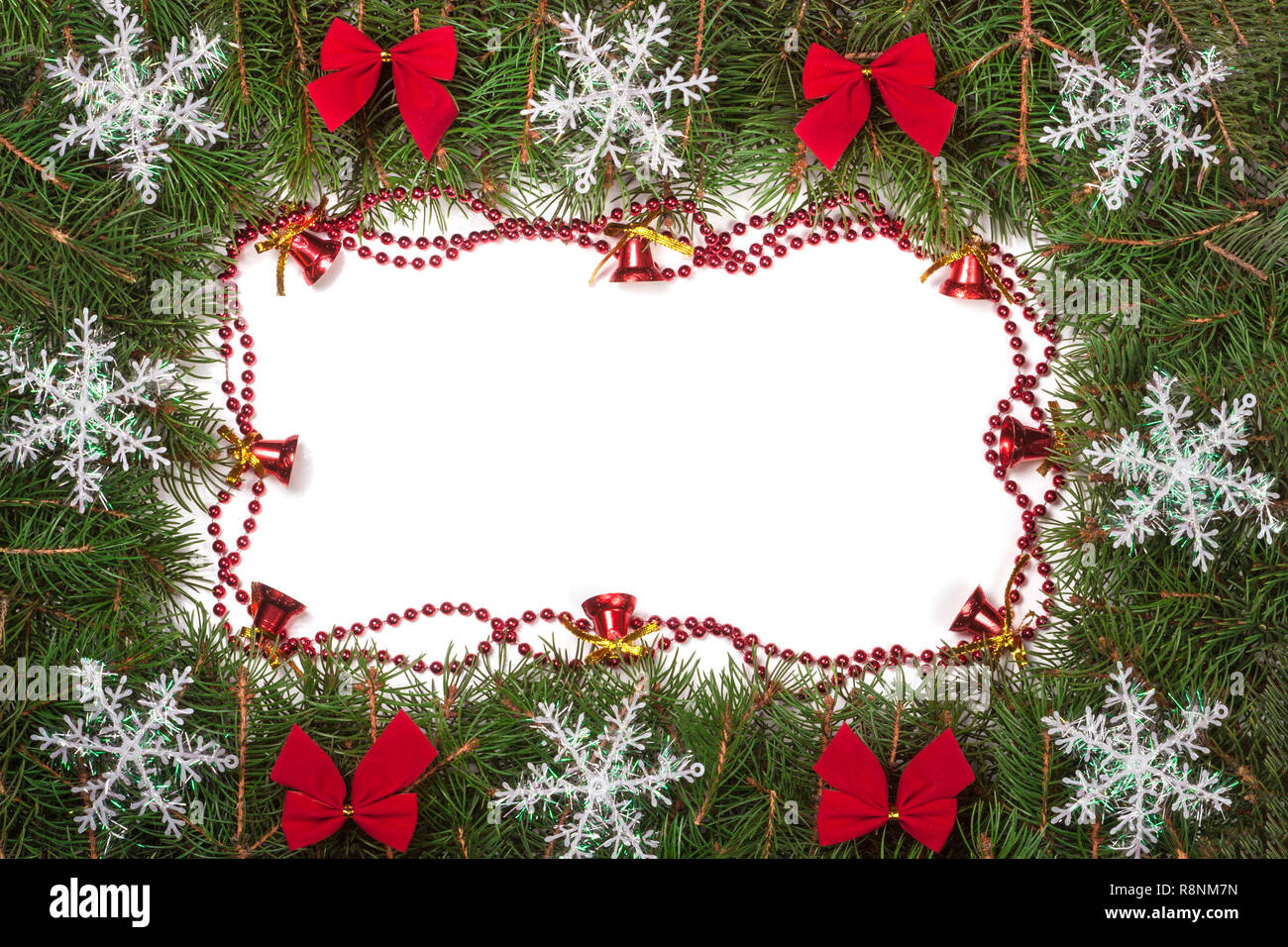 Christmas frame made of fir branches decorated with bows bells and ...