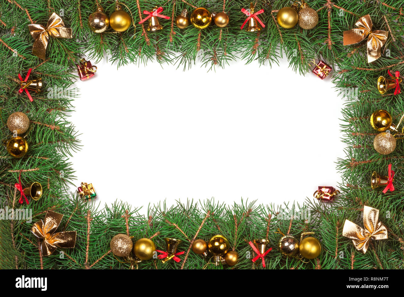 Christmas frame made of fir branches decorated with balls bells and ...