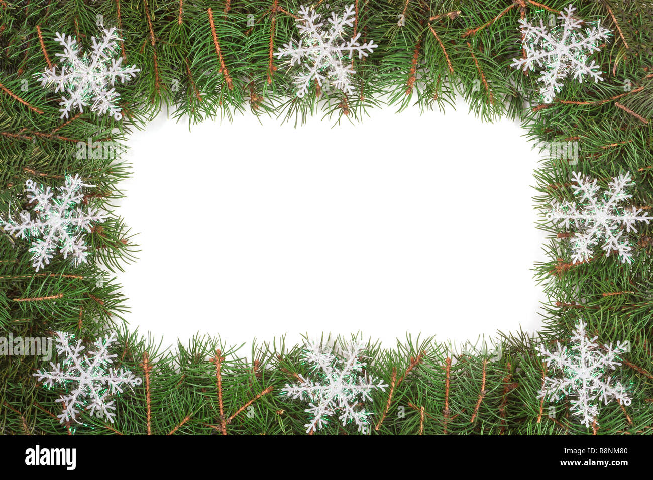 Christmas frame made of fir branches decorated with snowflakes isolated ...