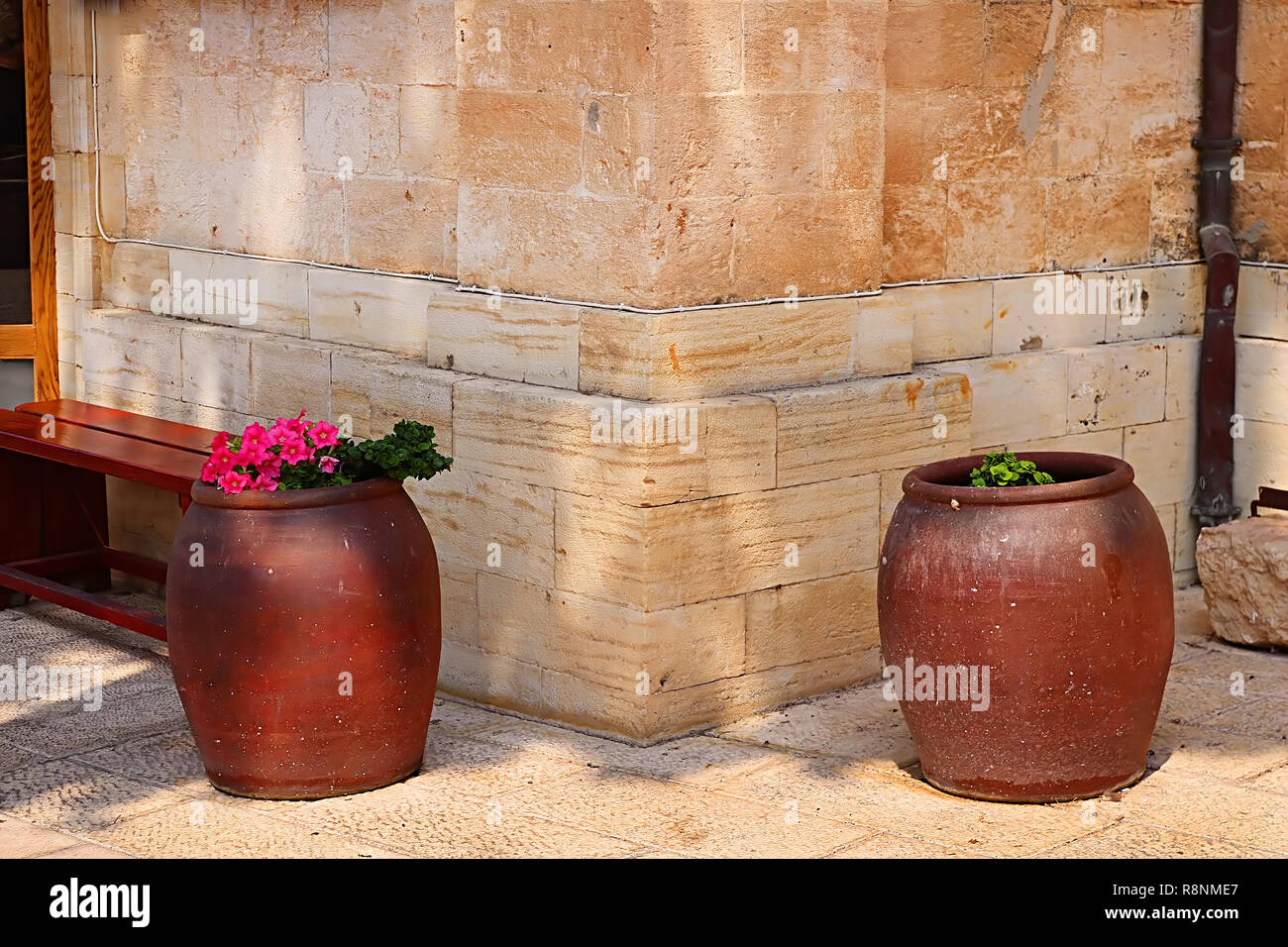 Bench and wine bowls with flowers near the Cana greek orthodox wedding
