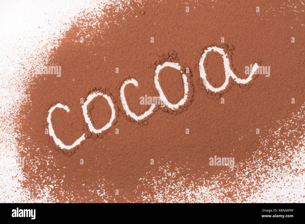 word cocoa written in cocoa powder isolated on white background Stock