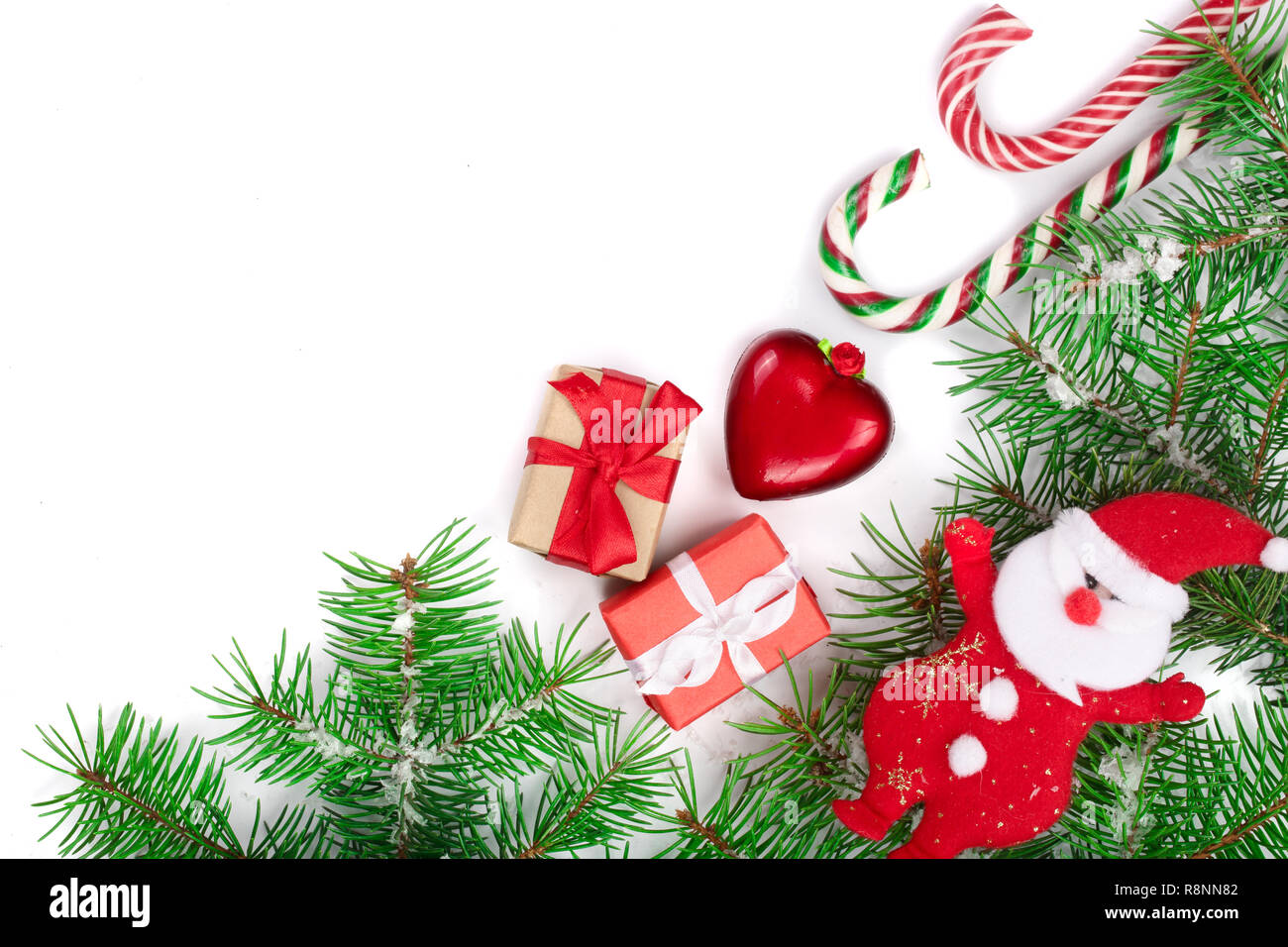 Christmas Frame of Fir tree branch with candy canes and snow isolated ...