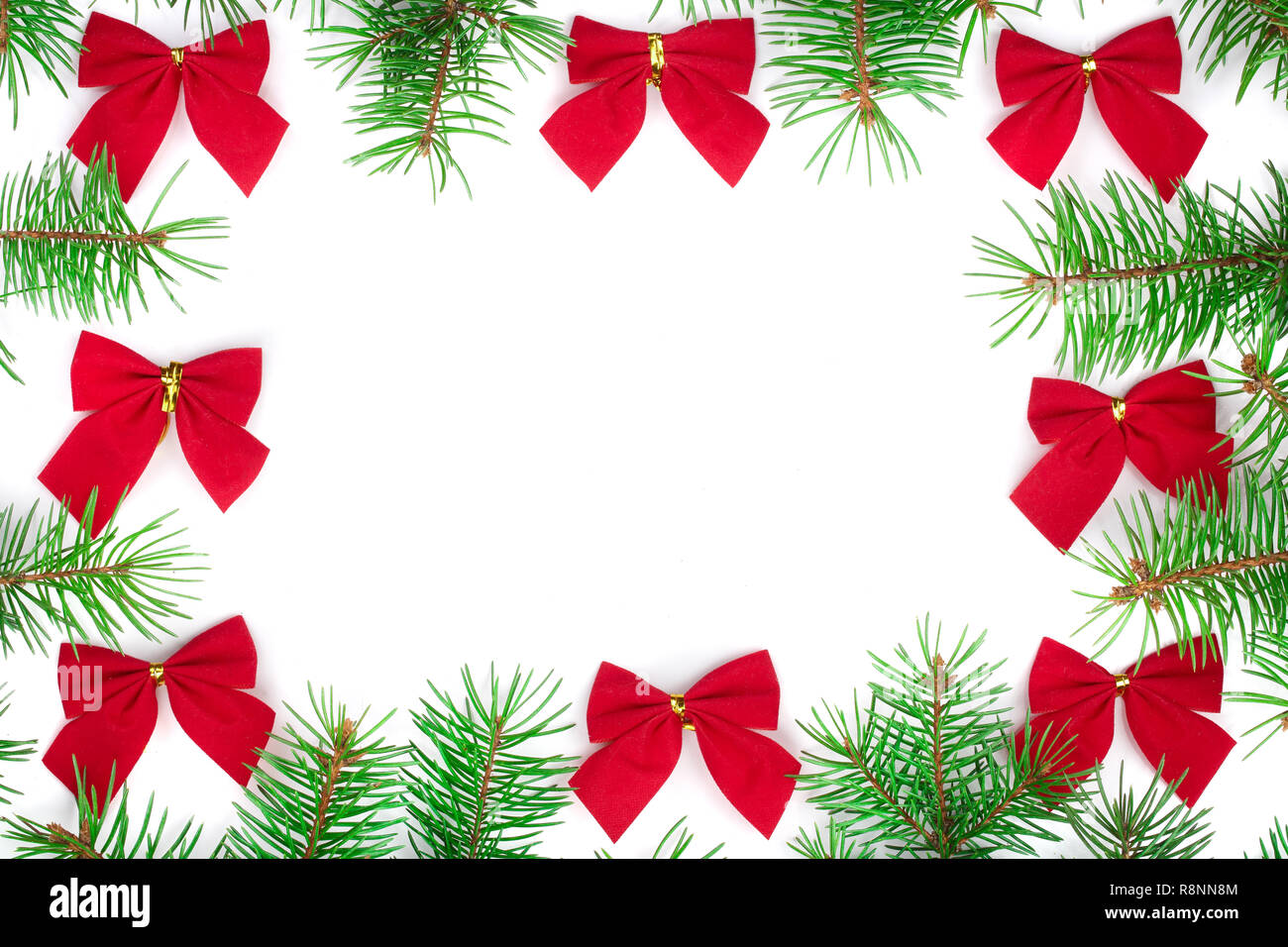 Christmas Frame of Fir tree branch with red bow isolated on white ...