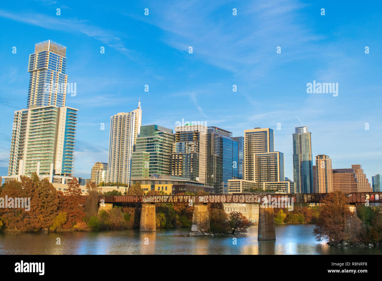 Autumn colors reflect on Lady Bird Lake under the booming skyline of Austin, Texas, consistently rated one of the best places to live in the USA. Stock Photo