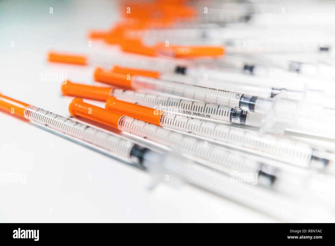 Close Up Shot Of A Pile Of Medical Insulin Needles With Orange Caps