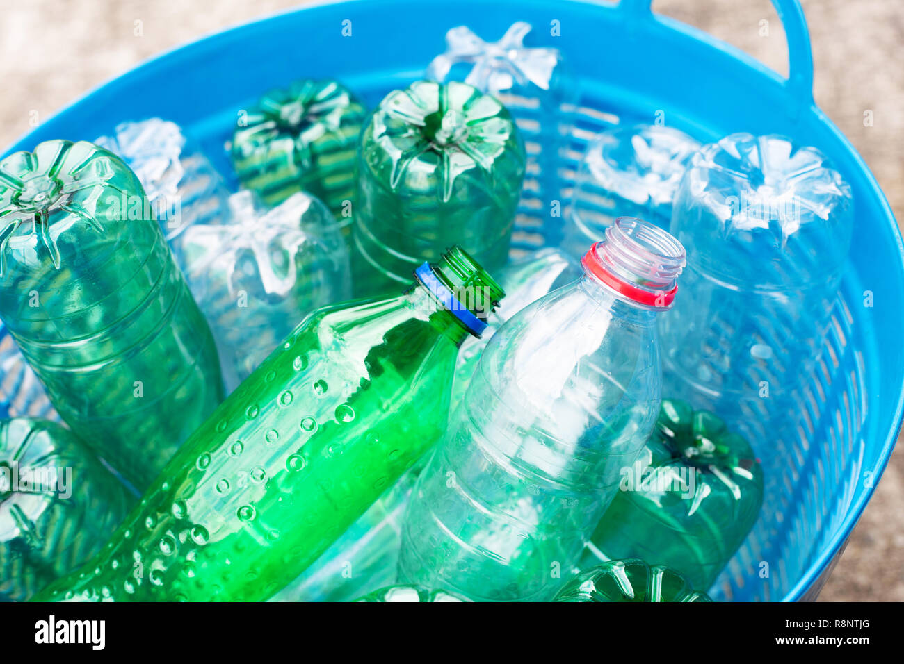 Plastic bottles in blue waste basket Stock Photo Alamy