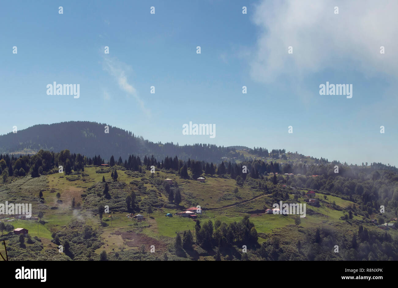 View of high plateau village, forest and mountain in fog creating beautiful nature scene. The image is captured in Trabzon/Rize area of Black Sea regi Stock Photo