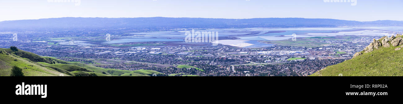 Panorama view of the cities on the shoreline of south and east San Francisco bay area; colorful salt ponds in the background; Silicon Valley, Californ Stock Photo