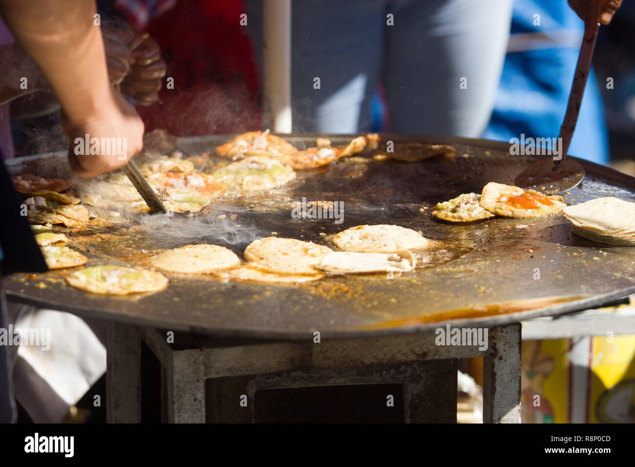 close up mexican street vendor cooking fry tacos with meat and sauce Stock Photo