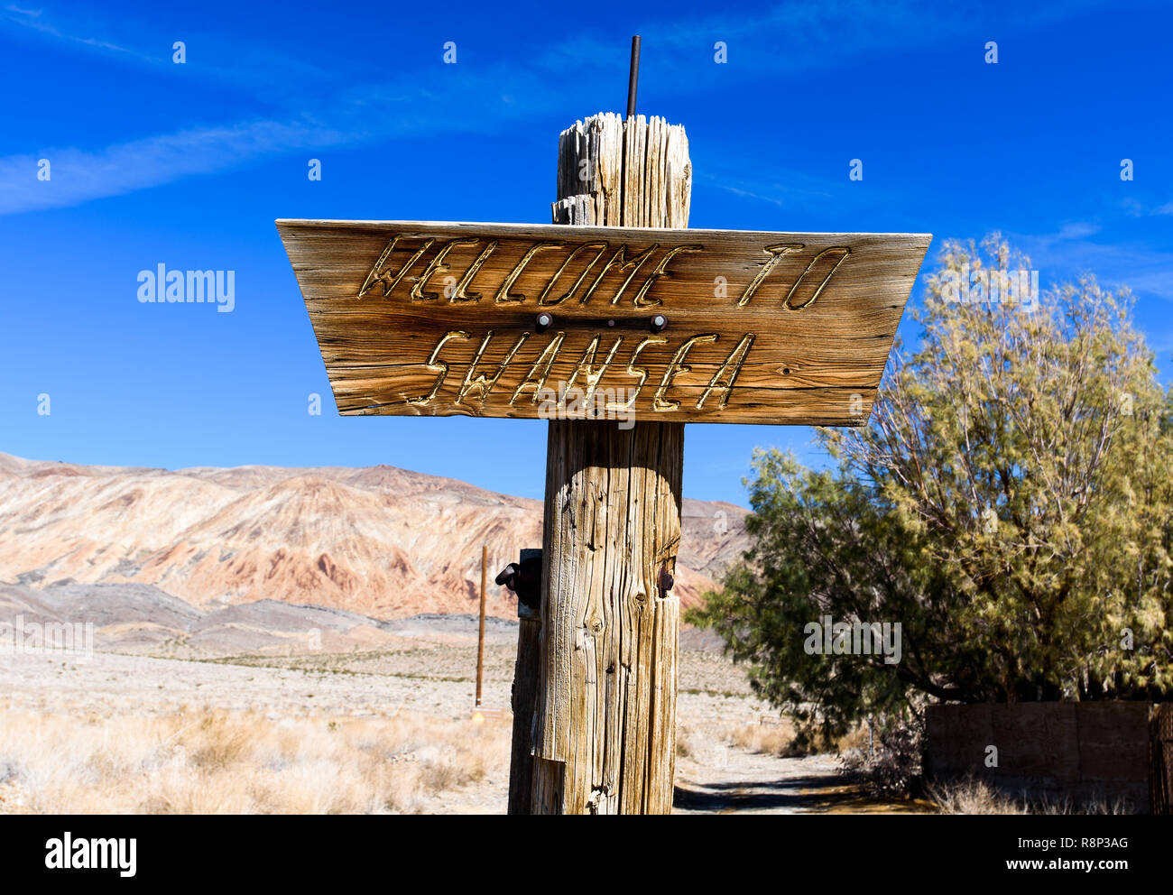 Wooden sign marking the former silver smelting boomtown, now a ghost town in California Stock Photo