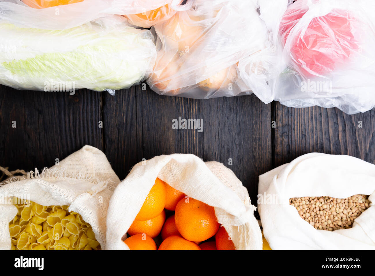 Fresh vegetables and fruits in eco cotton bags against vegetables in