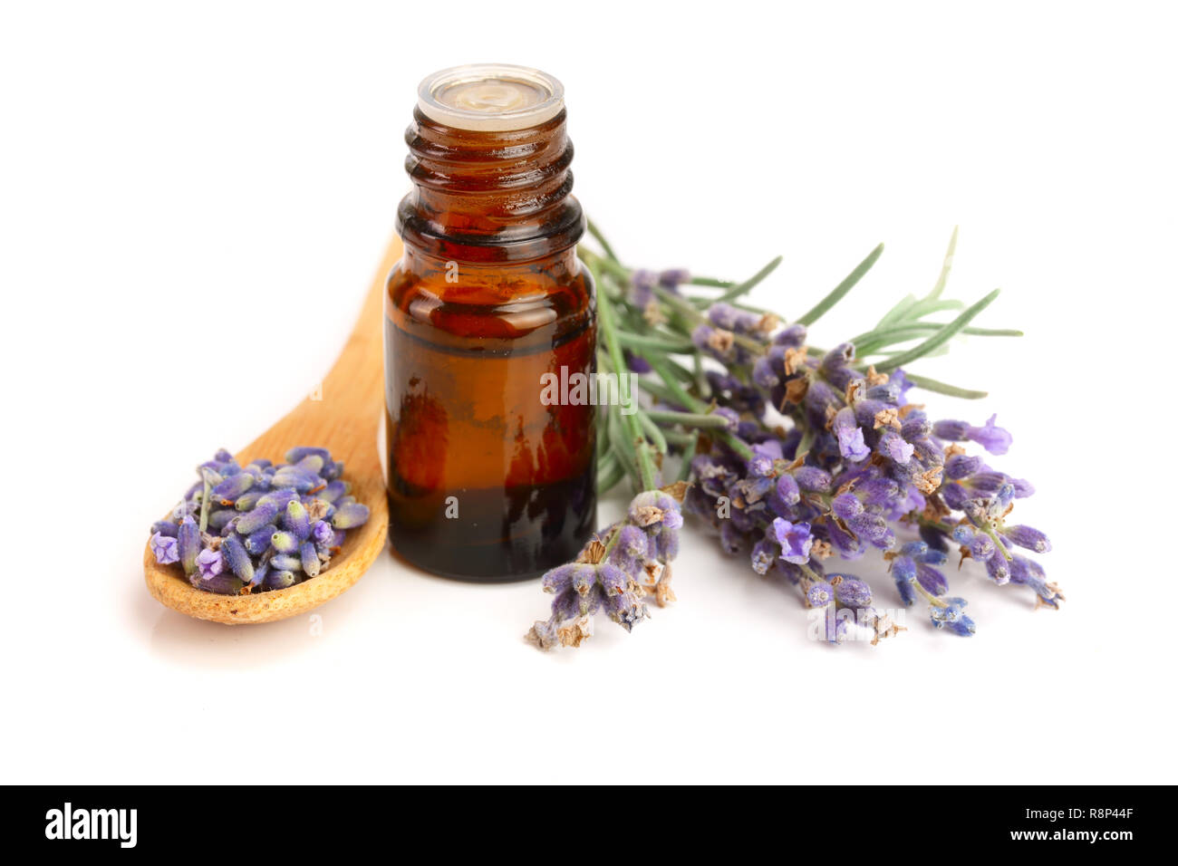 Bottle with aroma oil and lavender flowers isolated on white background Stock Photo