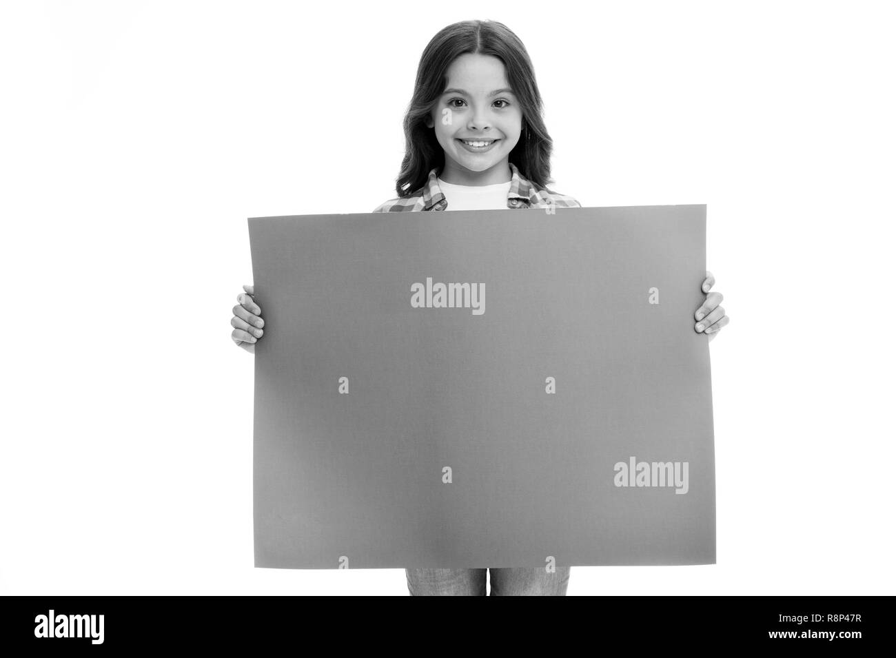 advertisement. little girl hold paper for advertisement. advertisement child with place for copy space. advertisement and presenting product concept. yout advertising here. Stock Photo