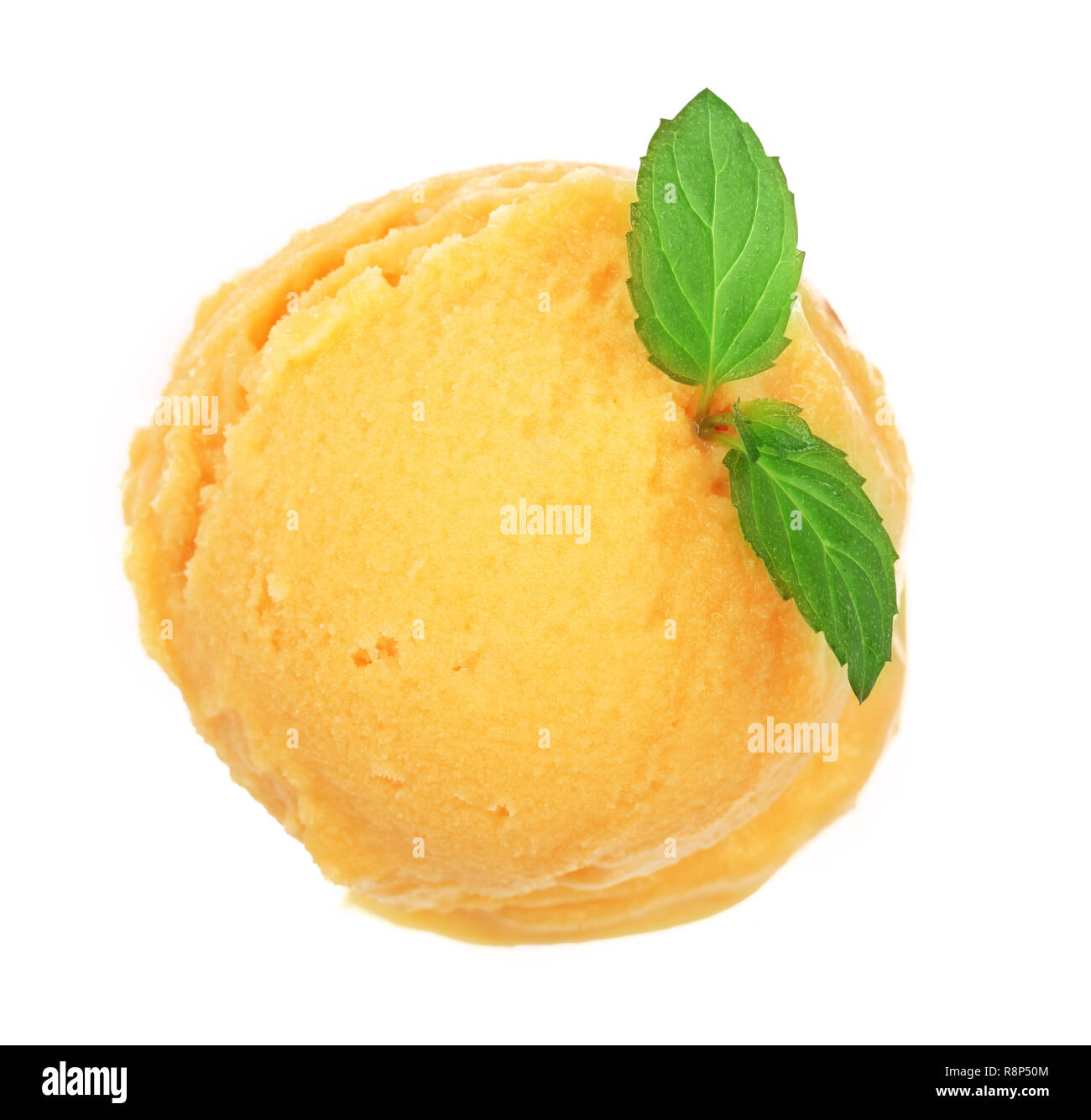 Yellow ice cream with a mint leaf top view isolated on white background Stock Photo