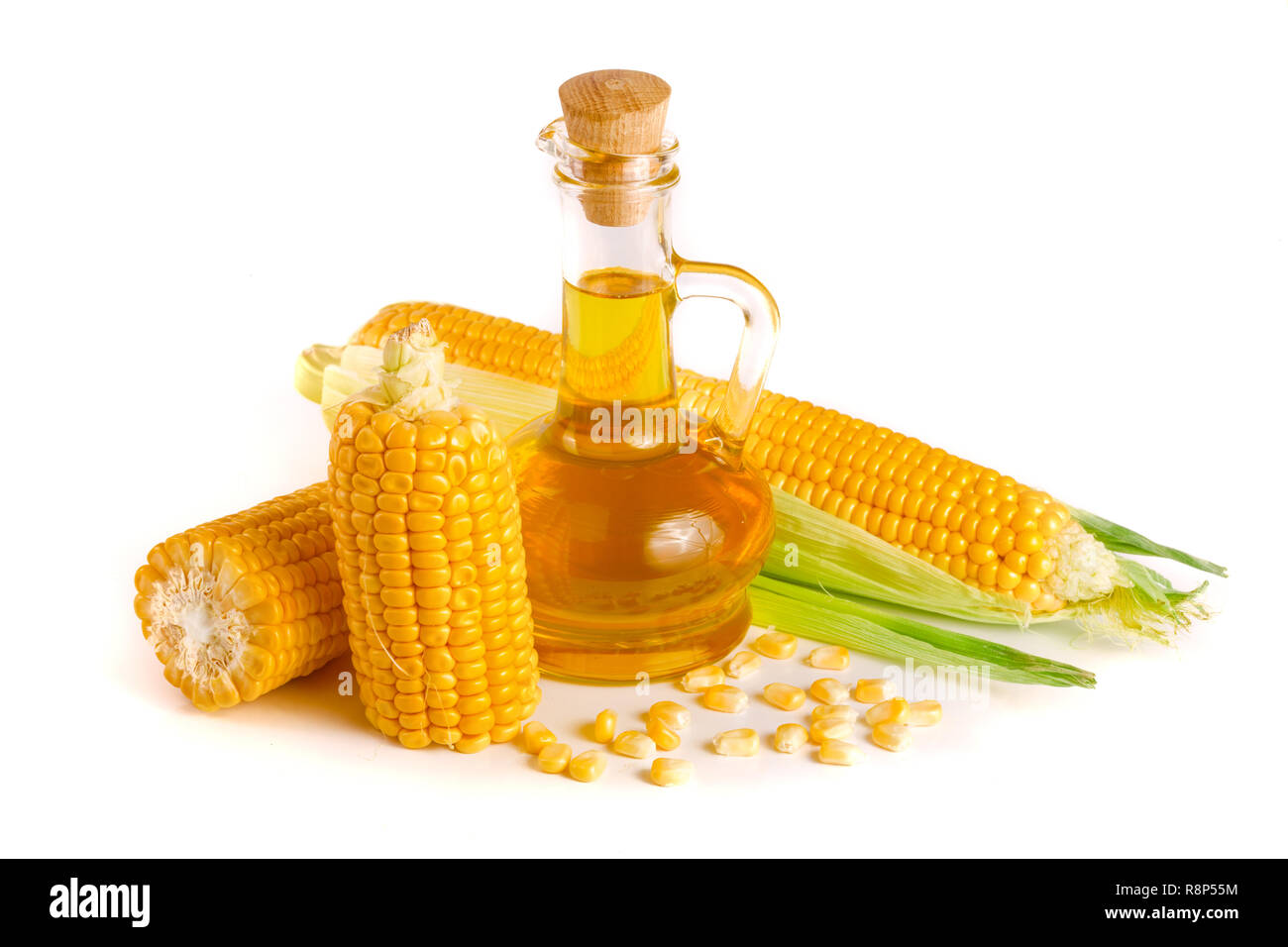 Corn oil in decanter, fresh corn cobs and grains isolated on white background Stock Photo