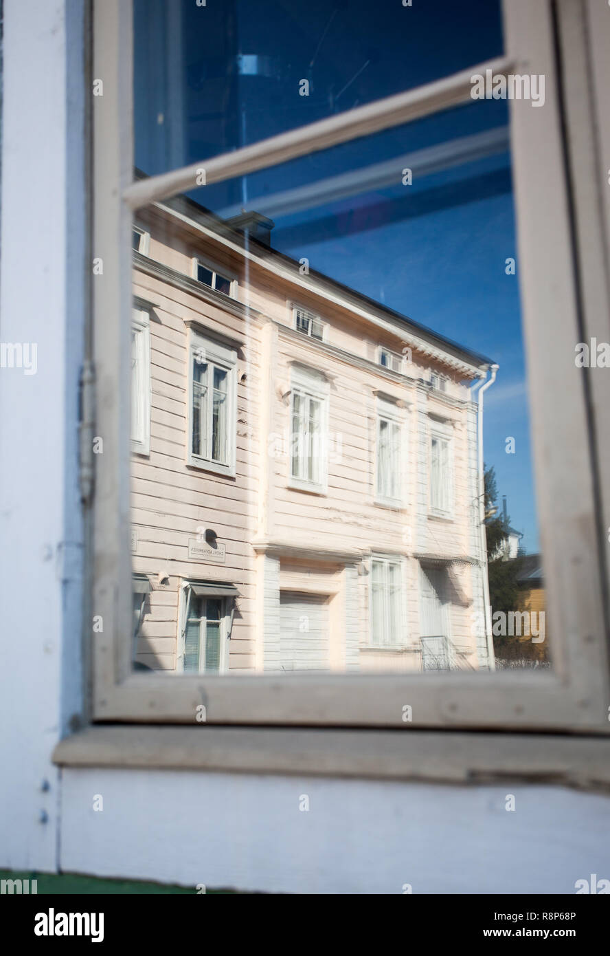 Relected wooden building in window, Porvoo, Finland Stock Photo