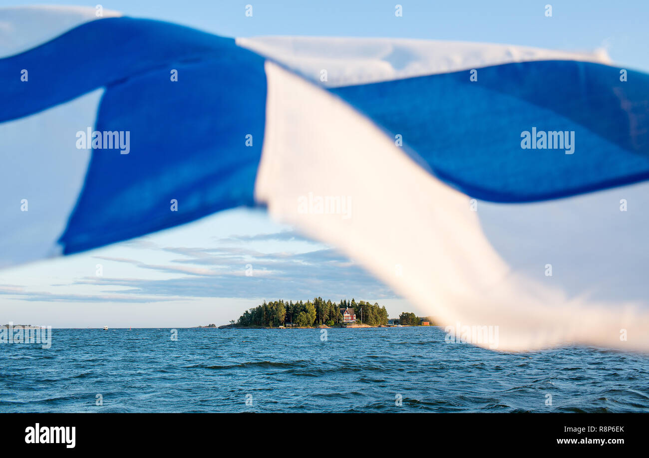 View of Finnish archipelago from boat with Finnish flag, Helsinki, Finland Stock Photo