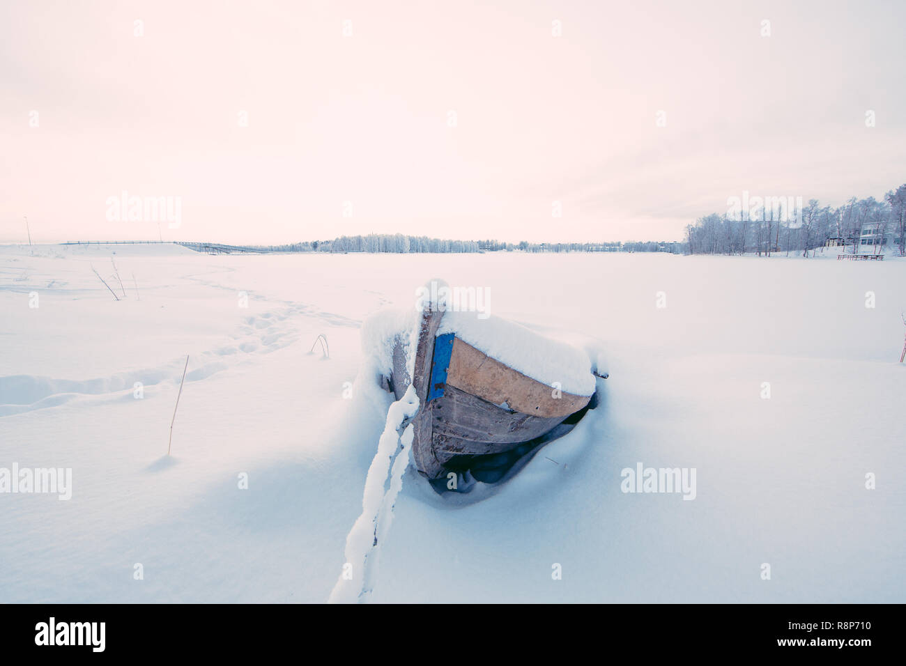Wooden Rowing Boat by frozen lake in Kuusamo, Finland Stock Photo