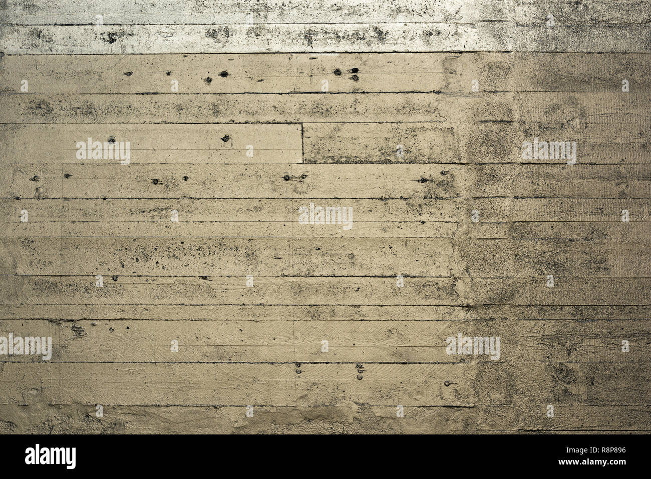 A striped silver gold colored concrete wall Stock Photo