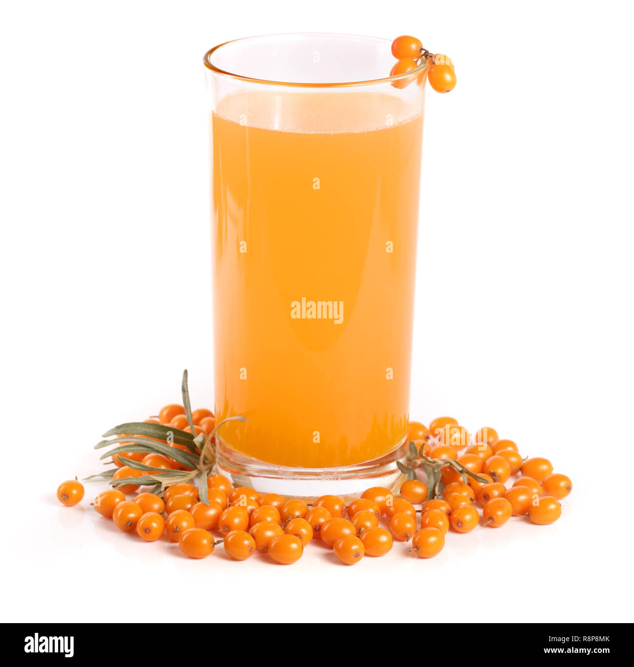 Sea buckthorn juice in a glass with berries isolated on a white