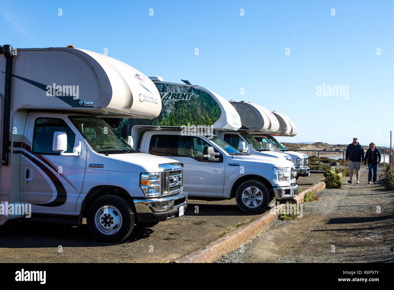 Row of RV's parked in parking lot off California Highway one (PCH, Pacific coast highway) in San Simeon, California; USA Stock Photo