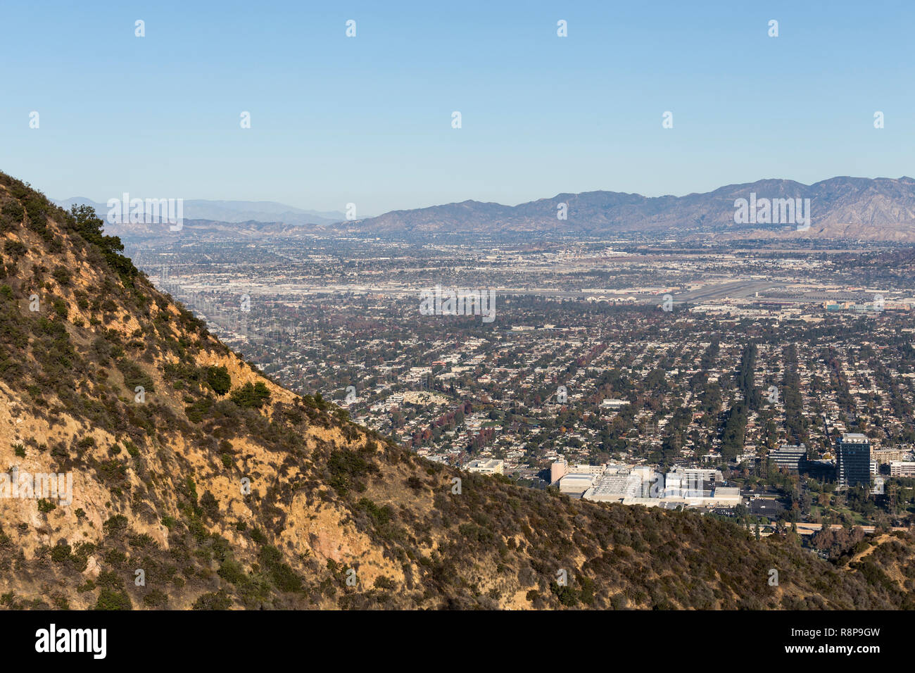 Burbank and the San Fernando Valley with the Verdugo Hills and San Gabriel Mountains in background.  Shot taken from hilltop at Griffith Park in Los A Stock Photo