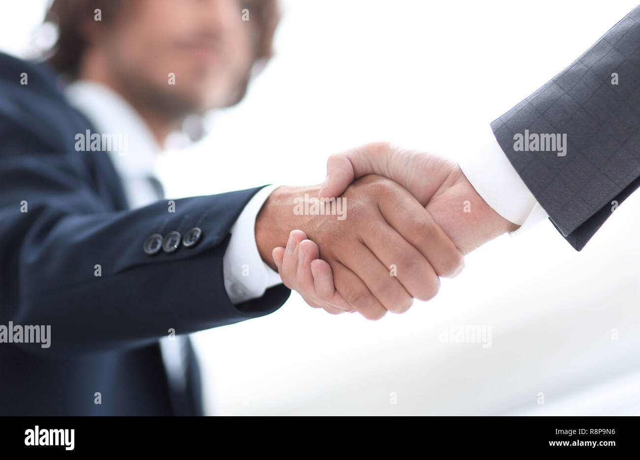 Two businessman shaking hands greeting each other Stock Photo - Alamy