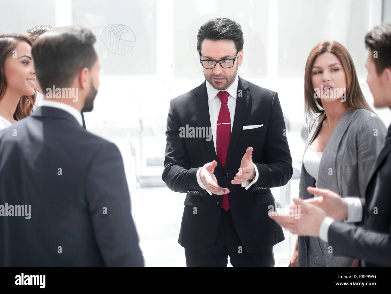 close up.a group of employees talking standing in a circle Stock Photo ...