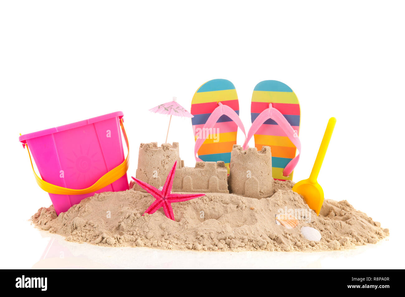 Sand castle andd toys at the beach isolated over white background Stock Photo