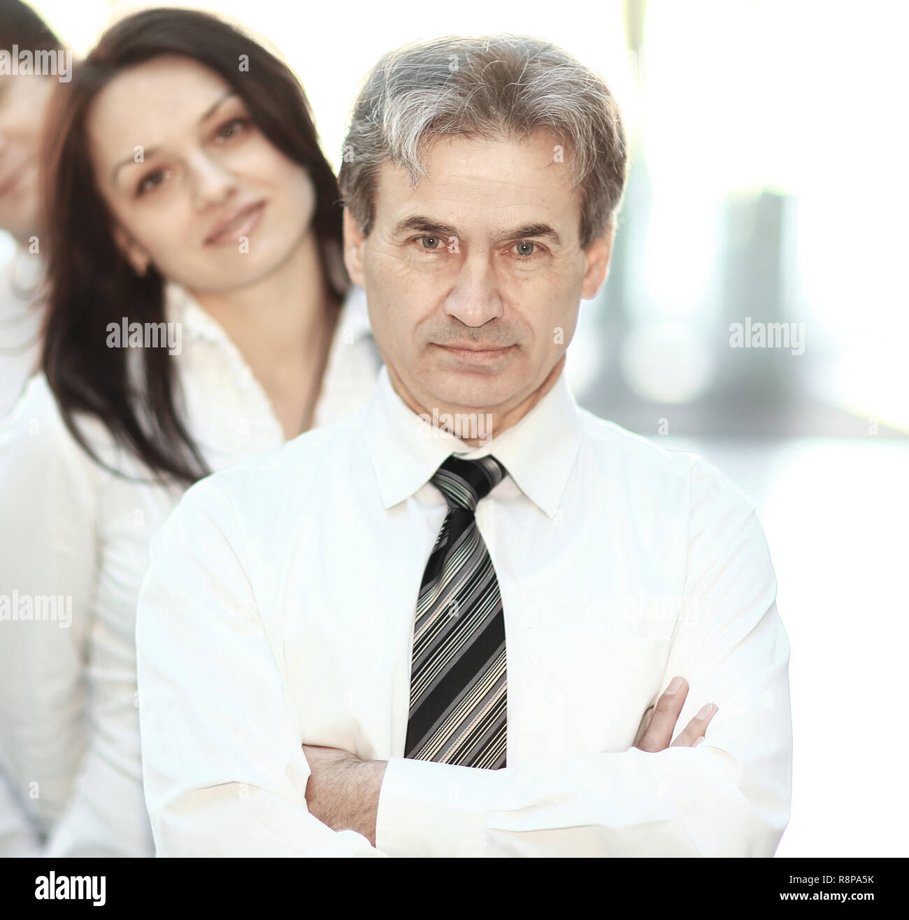 leader and the business team standing behind him Stock Photo - Alamy