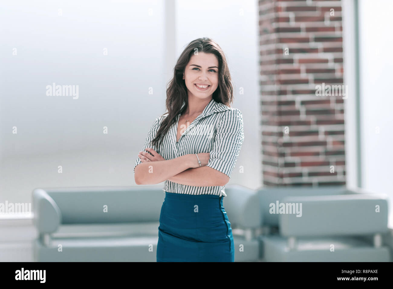 smiling young business woman standing in the office lobby Stock Photo ...