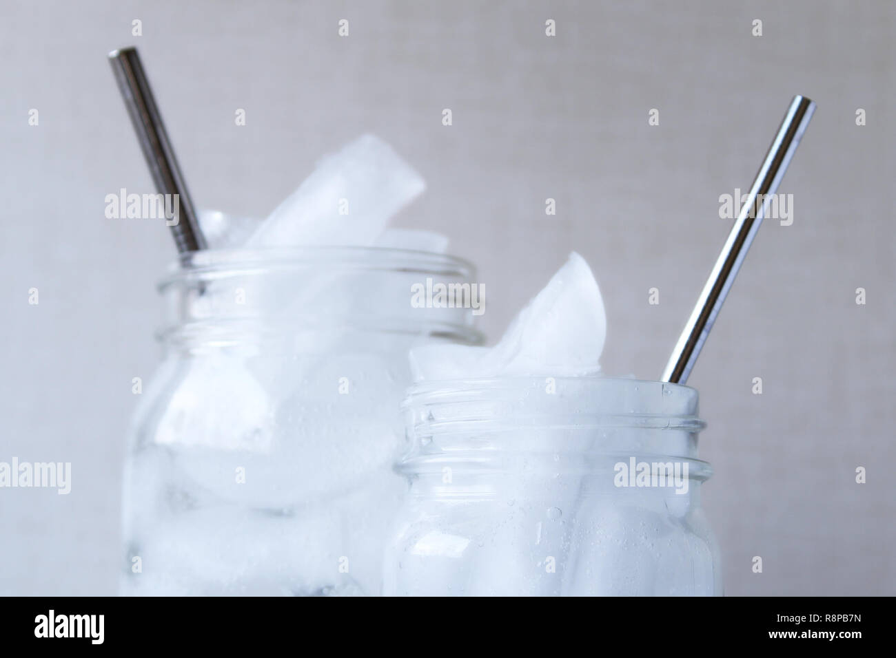 Sustainable resources concept with glass drinking glasses with stainless steel straws. Stock Photo