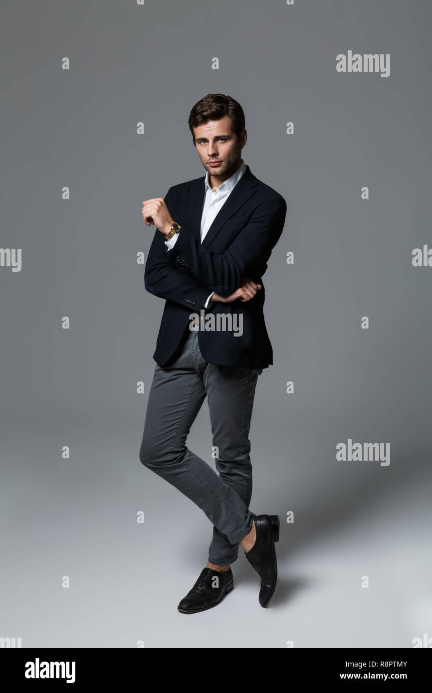 Full length portrait of a handsome young businessman dressed in suit ...