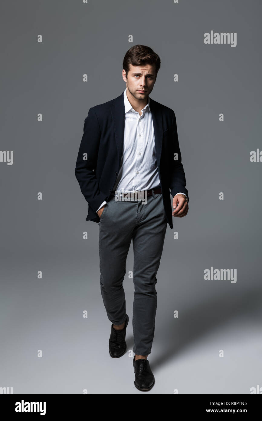 Full length portrait of a handsome young businessman dressed in suit ...