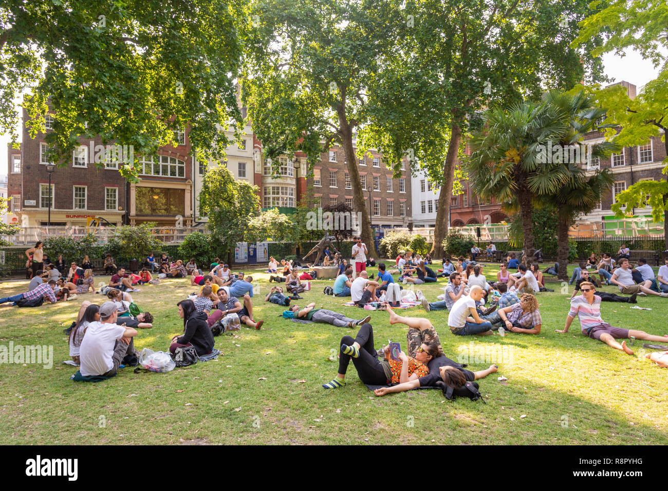 People relaxing in Soho Square , London, UK Stock Photo