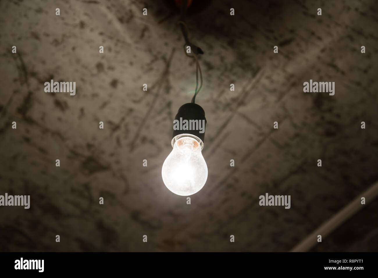 Light bulb closeup in a dark room. Beginning of the repair Stock Photo