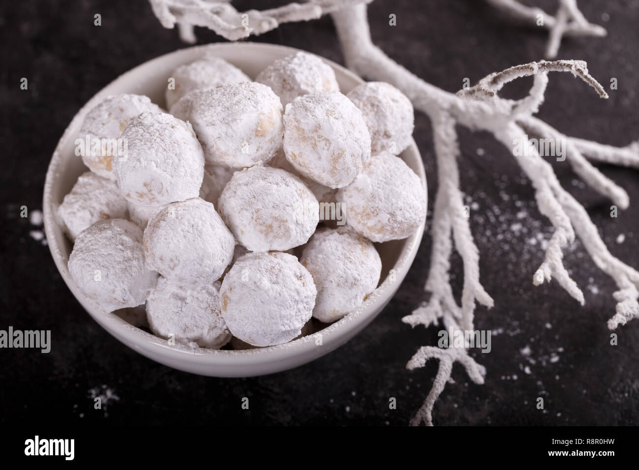 Traditional Greek Christmas cookies with almonds snowball on black sotne background Stock Photo