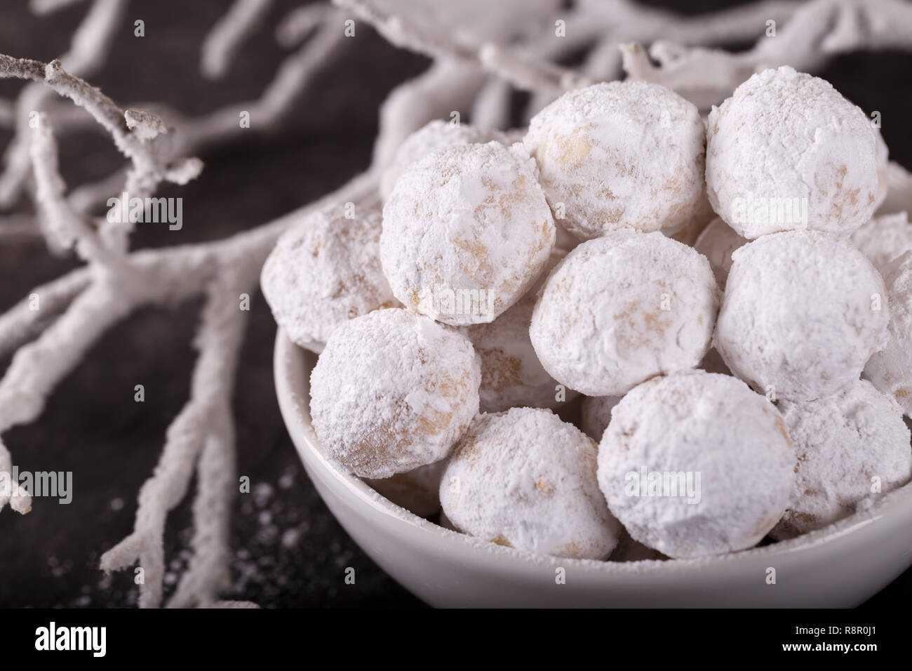 Traditional Greek Christmas cookies with almonds snowball on black sotne background Stock Photo