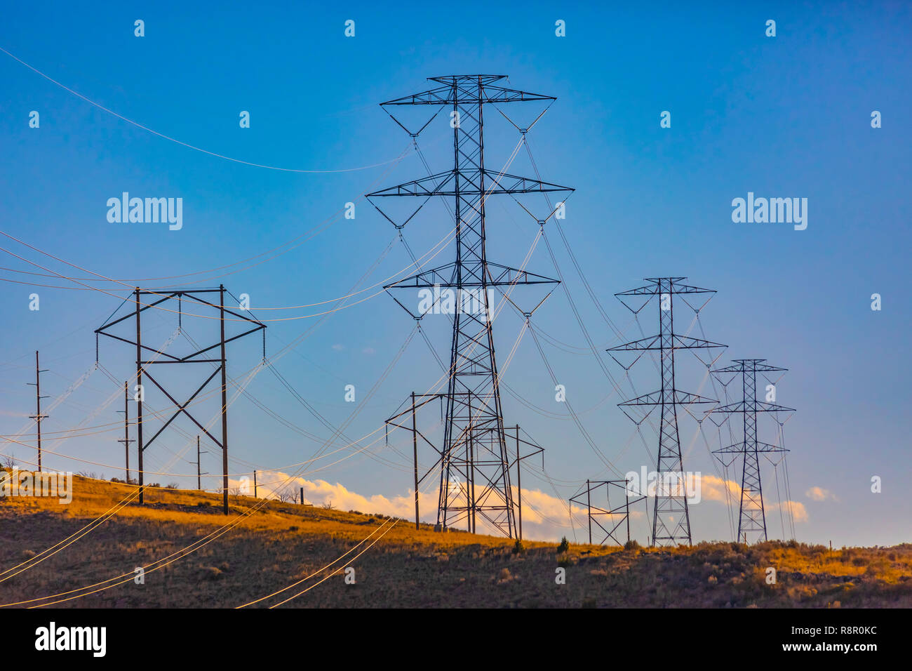 Electrical towers in the distance on the horizon Stock Photo