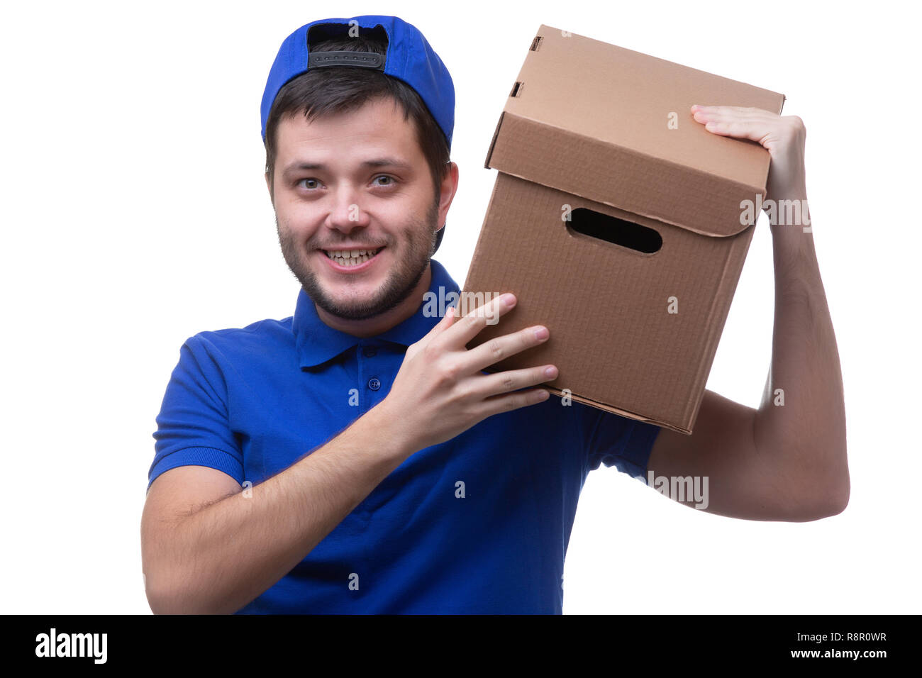 Photo of man in blue t-shirt and baseball cap with cardboard box on ...