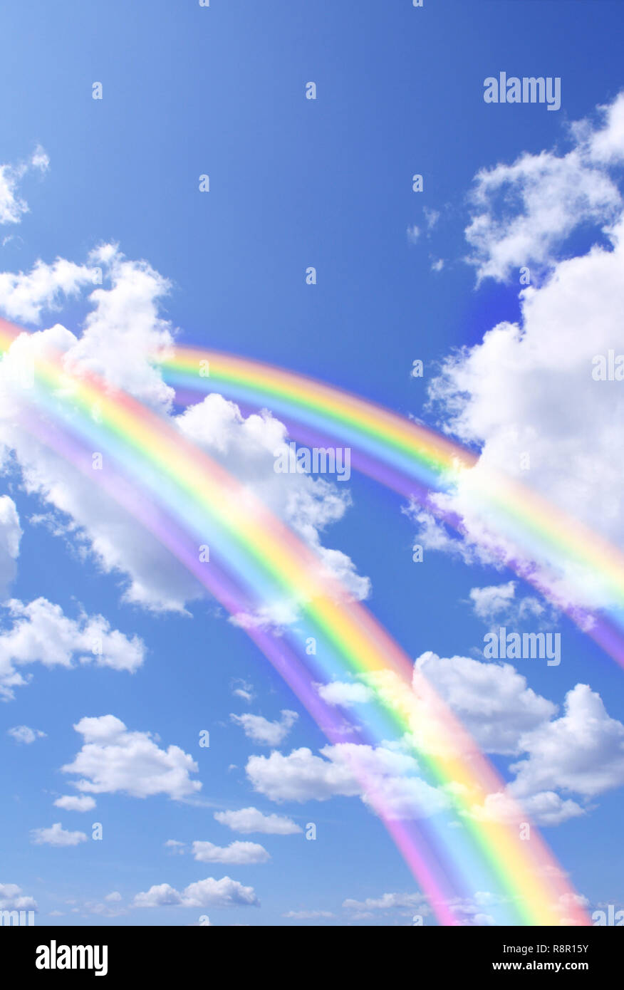 Two beautiful bright rainbows in the blue sky Stock Photo - Alamy